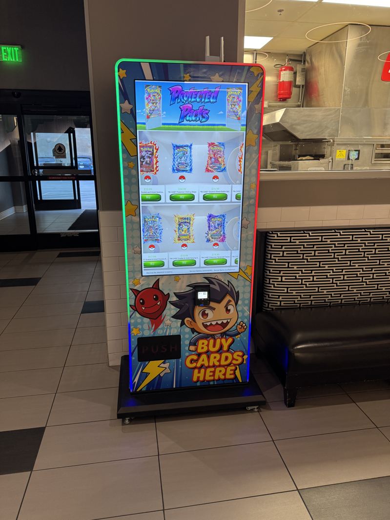 Tall lit kiosk in a restaurant seating area